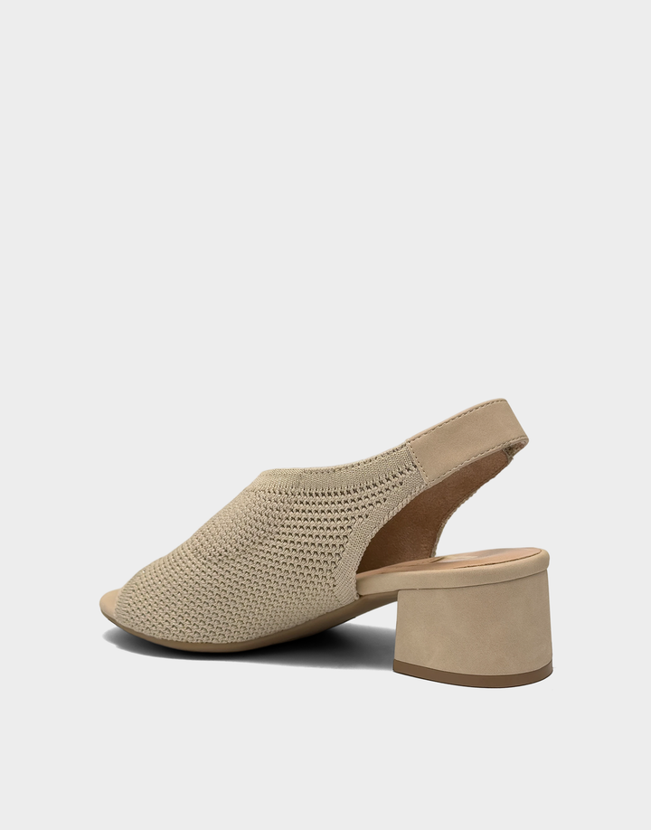 Lateral side view of the Costi block heel in Soft Gold Knit highlighting the low-profile construction and flexible comfort collar.