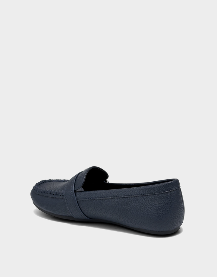 Lateral view of the Dinetta navy slip-on loafer highlighting the Stitch 'N Turn construction for out-of-the-box flexibility.