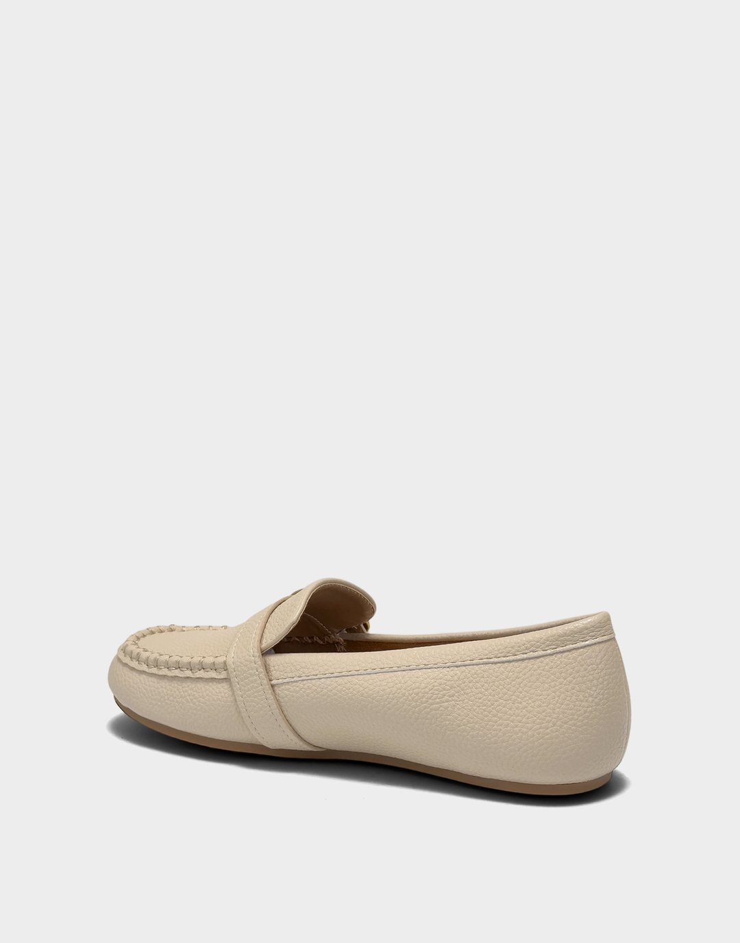 Lateral view of the Dinetta slip-on loafer in Stone highlighting the Stitch 'N Turn construction for superior flexibility.