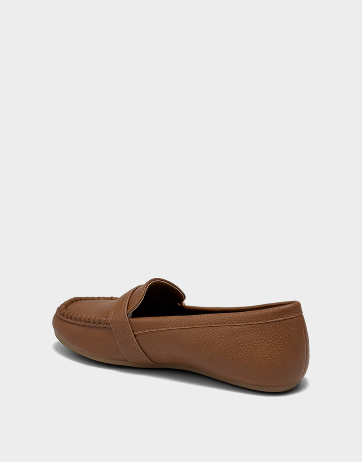 Lateral view of the Dinetta tan slip-on loafer highlighting the Stitch 'N Turn construction for immediate, out-of-the-box flexibility.