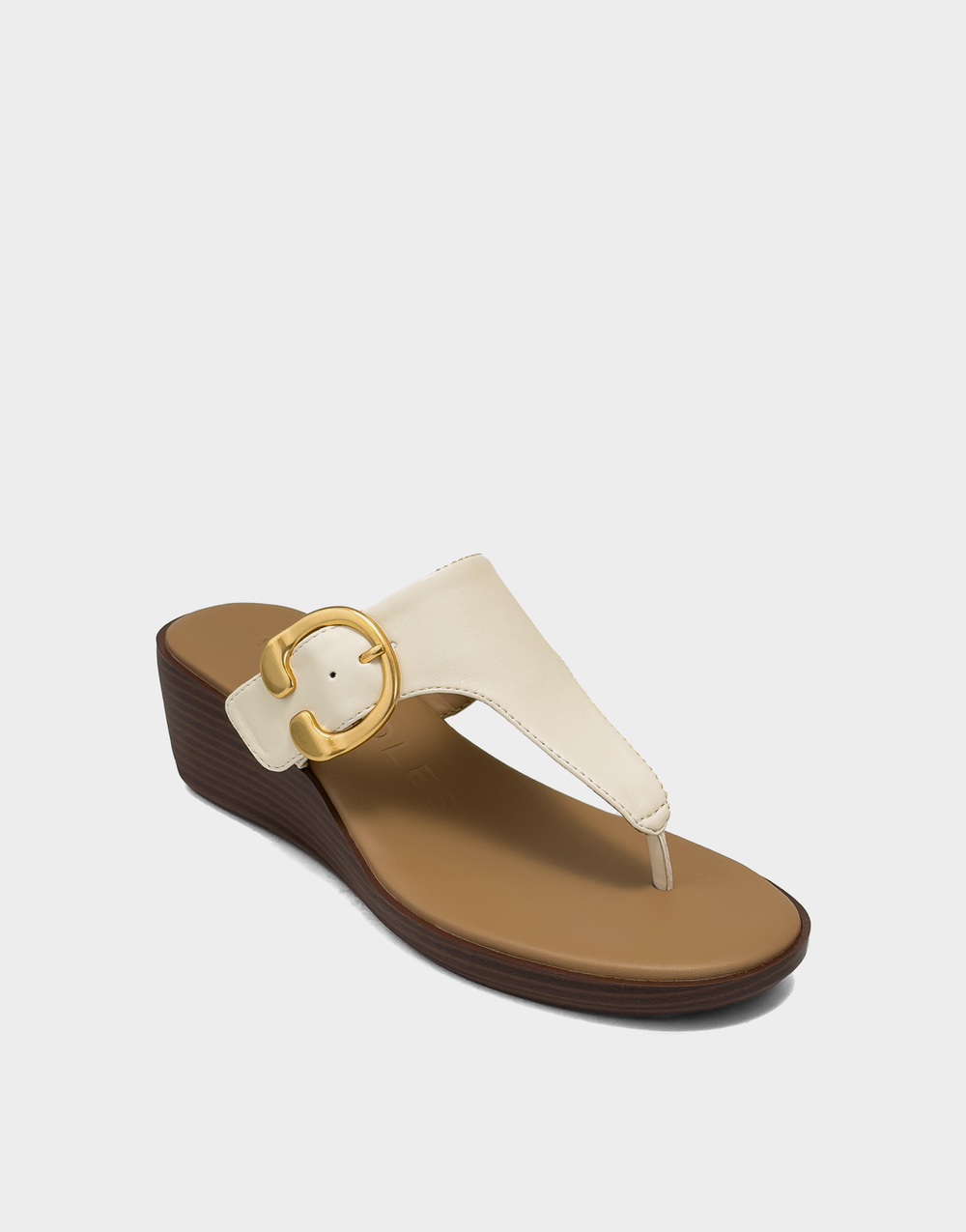 Angled shot of the Aerosoles Izola eggnog wedge showcasing the classic round toe and smooth, creamy faux leather finish.
