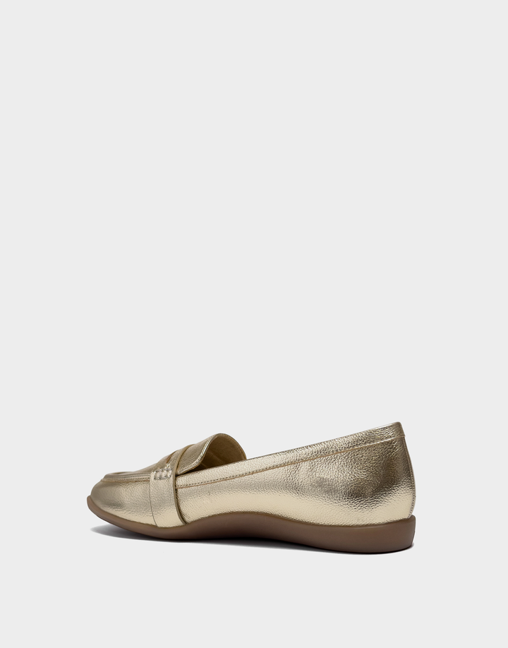 Lateral view of the Kody slip-on loafer in gold highlighting the Stitch 'N Turn construction for superior flexibility and a custom-fit feel.