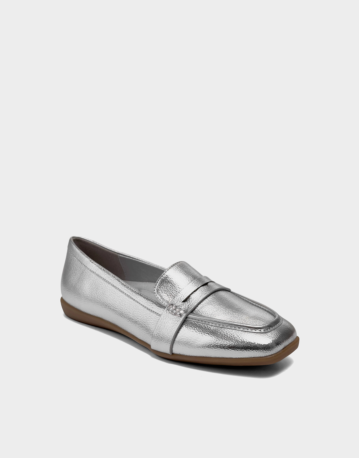 Angled view of the Aerosoles Kody silver loafer showcasing the classic penny strap and high-shine metallic textured finish.